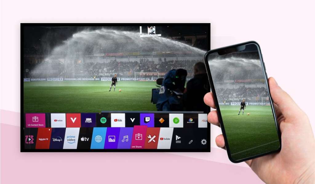 A hand holding an iPhone that is mirroring an image of a sports match to an LG Tv with WebOS interface