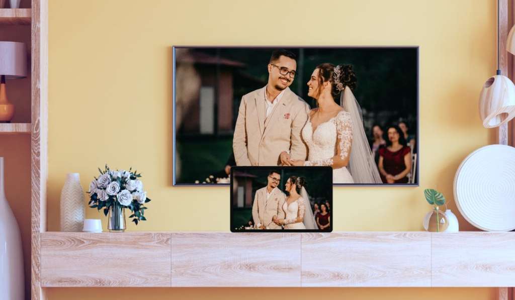 screen mirroring an image of bride and groom from MacBook to a TV in a living room